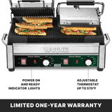 A stainless steel Waring Dual Panini Grill with ribbed cast iron plates and three sandwiches inside. Features labeled include power and ready indicator lights, an adjustable thermostat up to 570°F, and a Limited One-Year Warranty note at the bottom.