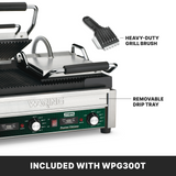 A Waring WPG300T dual panini grill with ribbed plates is shown open. A heavy-duty grill brush and removable drip tray are labeled. The control panel has knobs and lights. Text at the bottom reads: INCLUDED WITH WPG300T.