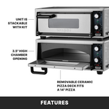 Two stainless steel electric pizza ovens are shown stacked. The lower oven’s door is open, revealing a removable ceramic pizza deck for a 14-inch pizza. Labels highlight this countertop pizza oven is stackable with a 3.5-inch high chamber opening.