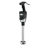 A heavy duty immersion blender with a black handle, control buttons on top, a sturdy motor body, and a long stainless steel blending shaft ending in a protective blade guard. The power cord extends from the handle’s top. Suitable for up to 40 quart capacity.