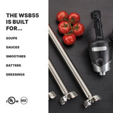 A heavy duty immersion blender with a 14" stainless steel shaft lies on a gray surface next to ripe tomatoes and two detachable shafts. On the left, text reads: THE WSB55 IS BUILT FOR... SOUPS, SAUCES, SMOOTHIES, BATTERS, DRESSINGS. Certification logos appear below.