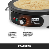 A close-up of a Waring Commercial electric crepe maker with a golden crepe cooking on the cast iron cook surface. The control panel displays power and ready lights, a temperature dial up to 570°F, brand logo, and feature labels.