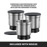 Three stainless steel grinding bowls with black lids are displayed. One bowl has its lid off, showing its empty interior, while the others are closed. Ideal for a Professional Spice Grinder, these removable, dishwasher-safe bowls come included with WSG30.