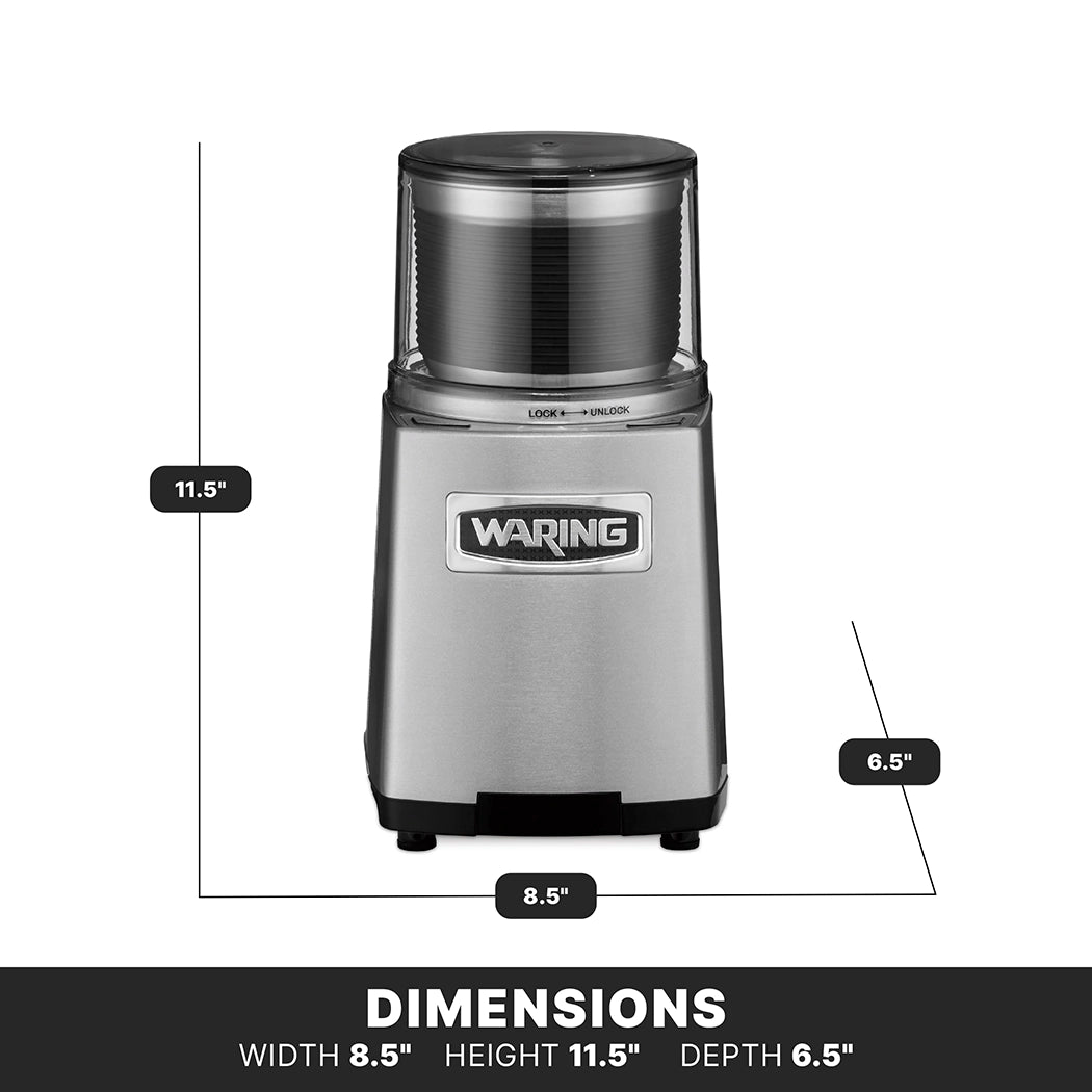 A silver Waring WSG60E commercial spice grinder is shown upright. Its width is 8.5 inches, height is 11.5 inches, and depth is 6.5 inches. The product features a transparent lid, front logo, and black measurement lines displaying dimensions.