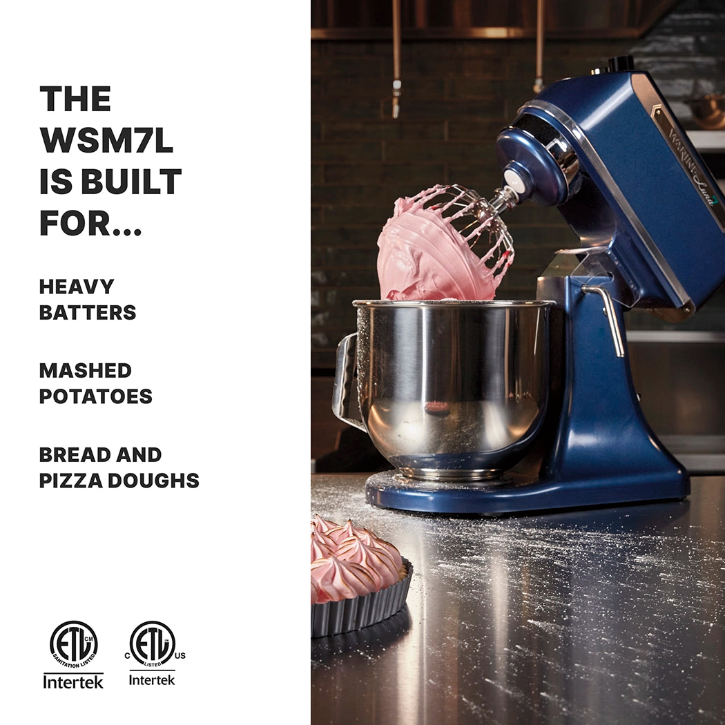 A deep blue Luna Planetary Mixer with a large metal bowl and whisk attachment is mixing pink batter in a modern kitchen. Pink meringue sits on the counter. Text reads: THE WSM7L 6.6 LITER MIXER IS BUILT FOR... HEAVY BATTERS, MASHED POTATOES, BREAD AND PIZZA DOUGHS.