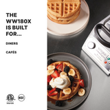 A plate with a waffle topped with sliced bananas, strawberries, blackberries, and whipped cream sits next to a heavy-duty Navarre Belgian Waffle Maker with non-stick plates and a stack of plain waffles. Text on the left reads: “The WW180X is built for... Diners Cafés.”.