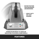 A silver Belgian Waffle Maker stands vertically. Labels point to the rotary feature for even baking, heavy-duty die-cast housing, and front LED indicators with audio chime. Non-stick plates make cleanup easy. Bold text below reads “FEATURES.”.