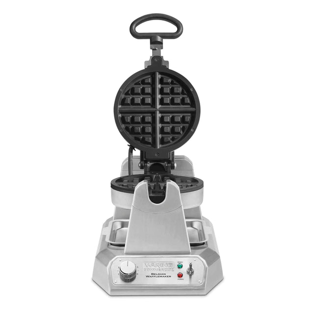 A stainless steel, commercial Belgian Waffle Maker with a round, open waffle grid, a top handle, control dial, and indicator lights on a rectangular base. The heavy-duty waffle maker faces forward with its grilling plates open.