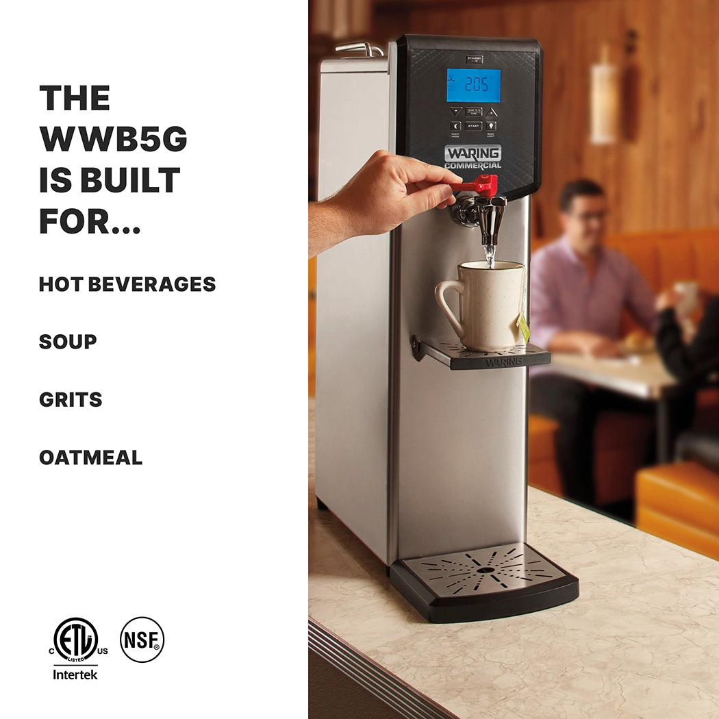 A hand dispenses hot water from a tall, stainless steel 5 gallon Waring Hot Water Dispenser into a mug. The digital display shows 205°F. This countertop unit is ideal for hot beverages, soup, grits, and oatmeal. Two people sit at a booth in the background.