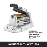 A Classic Waffle Maker with non-stick plates, shown open with a round waffle inside. Features include a labeled removable drip tray, control dial, indicator lights, and “INCLUDED WITH WWD180X” on a black bar at the base.