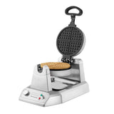 A Classic Waffle Maker with shiny stainless steel and non-stick plates features a round waffle inside. The open lid reveals the grid plates, knob, two indicator lights, drip tray, and a curved black handle for easy use.