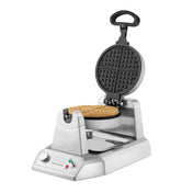 A Classic Waffle Maker with a stainless steel build and modern design, this appliance features a control knob, indicator lights, and a drip tray below the round waffle. Its upright lid and black handle add to its sturdy, commercial waffle maker appeal.