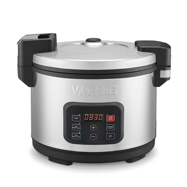 A PFAS-free commercial rice cooker, this stainless steel model features a non-stick ceramic-coated inner pot, a digital display showing 18:30, black handles, and the Waring brand embossed above the control panel with labeled buttons.