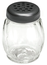 A clear, round glass cheese shaker with vertical grooves and a wide mouth, topped with a metallic lid featuring multiple evenly spaced circular holes. The jar is empty and designed for shaking out cheese, spices, or powdered condiments.