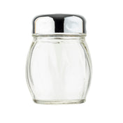 A clear, empty glass cheese shaker with subtle vertical grooves stands upright. It has a round, shiny metal lid with small holes for dispensing salt. The plain white background highlights the TableCraft cheese shaker’s simple, reflective design.