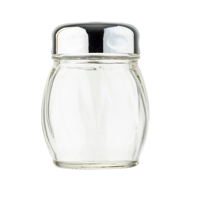 A clear, empty glass cheese shaker with subtle vertical grooves stands upright. It has a round, shiny metal lid with small holes for dispensing salt. The plain white background highlights the TableCraft cheese shaker’s simple, reflective design.