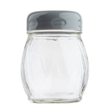 A small, clear Swirl Cheese Shaker from TableCraft Products with a grey plastic lid. The empty glass cheese shaker features a slightly rounded, ribbed body. Its transparent design stands out against the plain white background.