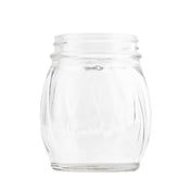 A clear, empty TableCraft 6 oz glass shaker jar with a wide mouth and rounded sides stands upright on a white background. Its transparent surface features subtle vertical indentations, making it an ideal replacement jar for your kitchen needs.