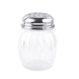 A clear, empty 6 oz glass shaker with vertical ridges, topped with a shiny, perforated metal lid. The TableCraft shaker stands upright on a white background, its lid featuring multiple small holes for dispensing contents.