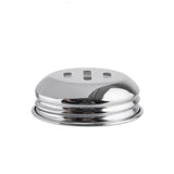 A shiny, round, silver metal object with three rectangular slots on top—likely a replacement shaker top or slotted chrome lid—is shown against a plain white background. Its reflective, smooth surface and ridged edges evoke classic swirl glass shakers.