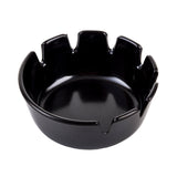 A glossy black deepwell ashtray with a round shape, featuring six evenly spaced notches along the rim for holding cigarettes. The ashtray has a smooth, reflective surface, a slightly concave center, and is dishwasher safe.