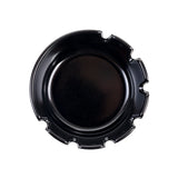 A round, shiny black phenolic ashtray with four grooves evenly spaced around the rim, designed for holding cigarettes. The deepwell ashtray is photographed from above on a plain white background.
