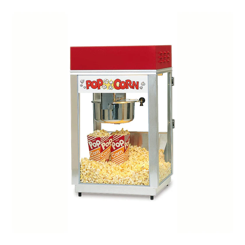 A classic countertop popcorn machine with a red top and clear glass sides. Inside, popped popcorn fills the bottom as two striped “POP CORN” boxes sit among the kernels. The 6 oz. kettle is suspended above in this Deluxe 60 Special Popcorn Popper.