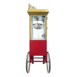 A vintage-style antique deluxe popcorn machine with a gold and red body, ornate trim, glass enclosure, and two large spoked wheels. The popcorn kettle is visible inside, with a small door on the right side for easy access.