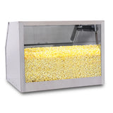A large silver and glass popcorn storage cabinet filled to the top with yellow popcorn. Clear panels offer a full view inside, while LED lighting highlights the popcorn. The background is plain and the case is empty except for the popcorn.
