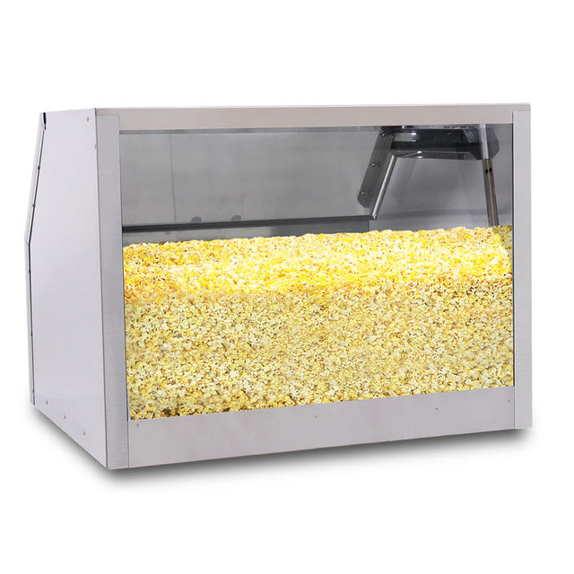 A large silver and glass popcorn storage cabinet filled to the top with yellow popcorn. Clear panels offer a full view inside, while LED lighting highlights the popcorn. The background is plain and the case is empty except for the popcorn.