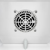 Close-up of a round, white ventilation fan with a black grille, mounted on a white ceiling near a commercial merchandiser refrigerator. Four visible screws secure the fan. A small, white, cone-shaped fixture is below it in this clean, minimalistic setting.