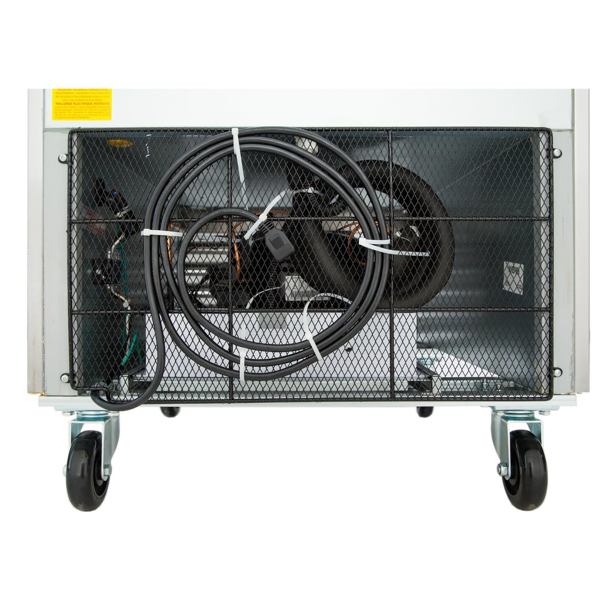 The image shows the underside of a commercial refrigerator on four wheels. A black power cable is coiled and secured to a metal mesh panel, revealing interior wiring and mechanical parts. The floor is white and the background is plain.