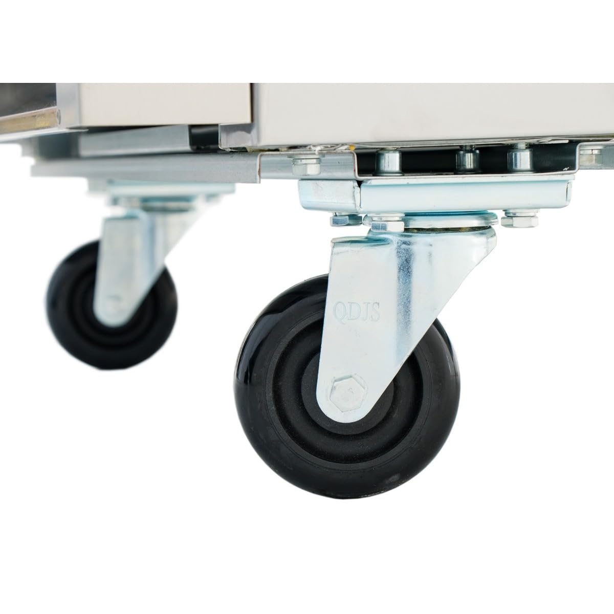 Close-up of two black rubber caster wheels attached to the frame of a stainless steel refrigerator. The wheels are mounted on silver metal brackets with visible bolts, with an out-of-focus floor in the background.