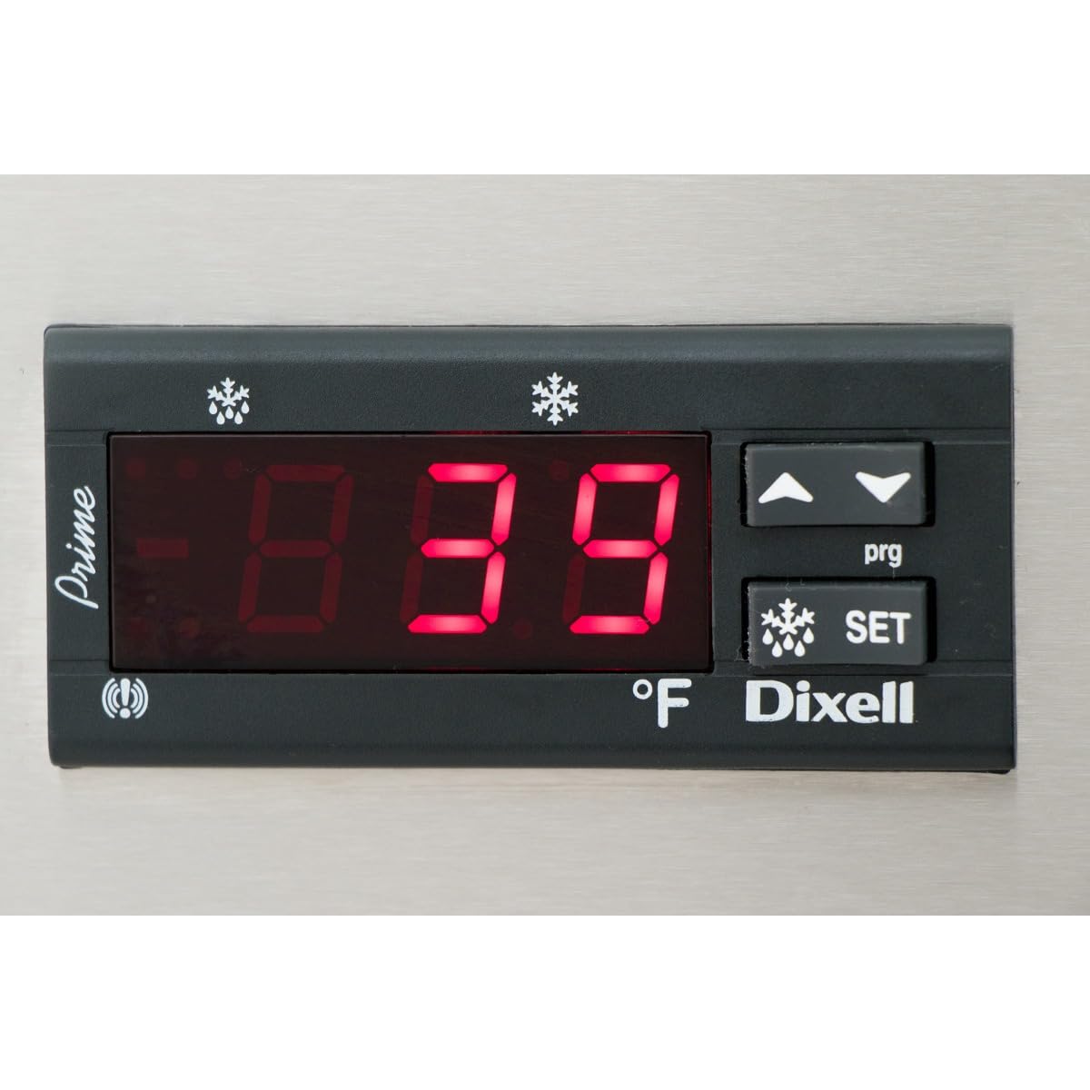 A close-up of a Dixell digital temperature controller on a commercial refrigerator displays 39°F in bright red numbers. The panel includes arrow buttons, a SET button, and snowflake icons, all set against stainless steel.