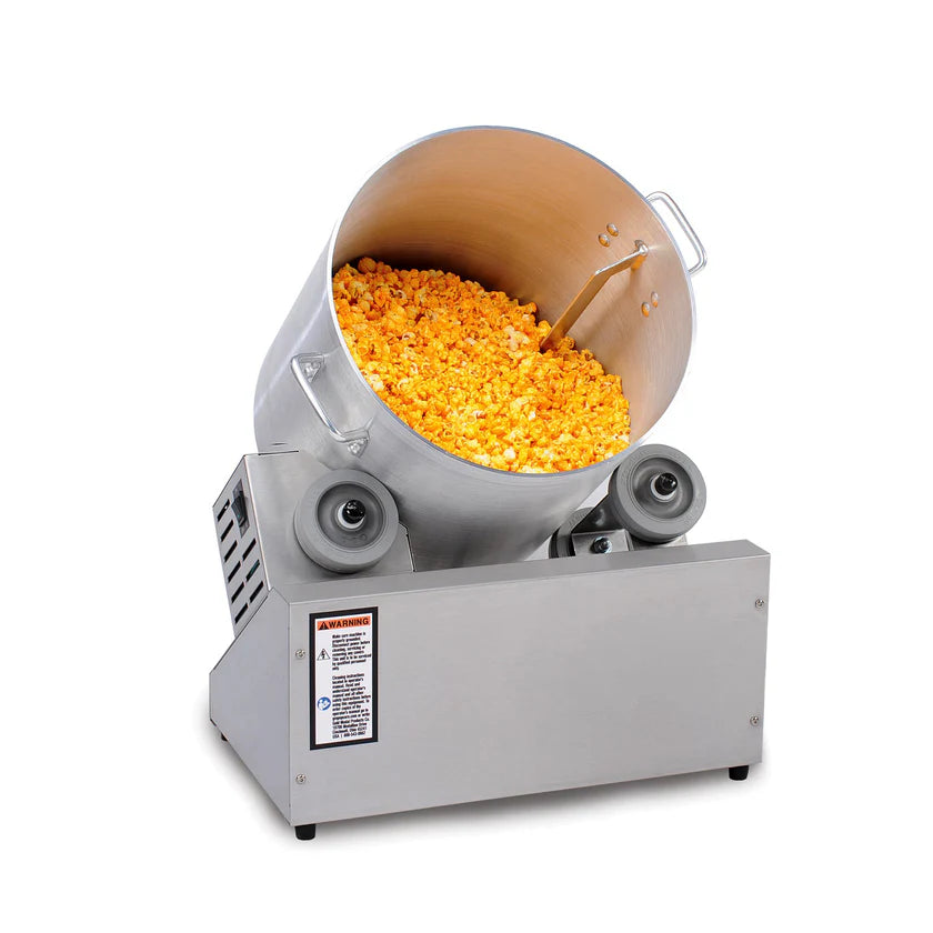 A large, metal Cheddar Easy Deluxe Tumbler from Gold Medal Products with a tilted, cylindrical drum filled with yellow popcorn; this blending pot features a sturdy base with two rollers and visible warning labels on the side.