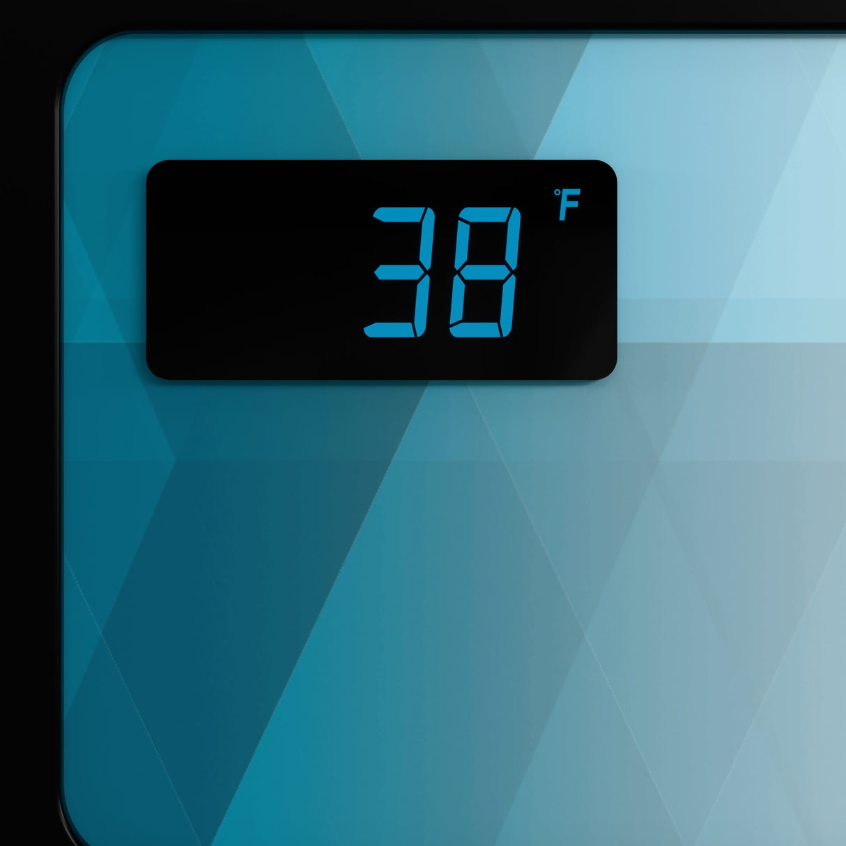 A digital display on a sleek glass door refrigerator shows 38°F in large blue numbers atop a glossy, geometric-patterned surface in blue and teal. The slim rectangular display with rounded corners is set in the upper left of the image.