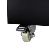 Close-up of a light-colored caster wheel attached to the bottom corner of a black panel on a commercial merchandiser refrigerator. The metal bracket features a foot-operated brake, all set against a plain white background for clear focus.