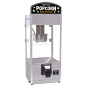 A self-serve popcorn popper with a silver metal frame, clear glass sides, a metal kettle inside, and a dispenser chute at the bottom. This countertop model features a top sign reading “Self Serve POPCORN HOT & FRESH” with popcorn graphics.