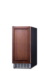 A compact built-in ice maker with a dark wood panel front, black sides, and a silver vent at the bottom. The wood front door has a rectangular raised border, giving this undercounter clear icemaker a cabinet-like appearance. Background is plain white.