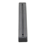 A black magnetic holder for knives with two visible metal strips running lengthwise. The rectangular strip features wall mount screw holes and a slightly rounded bottom edge. The background is plain white.