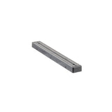 A long, rectangular, black and silver metallic object with a flat top and narrow grooves, viewed at an angle on a white background; it appears to be a precision tool or component, possibly a magnetic holder or metal straightedge.