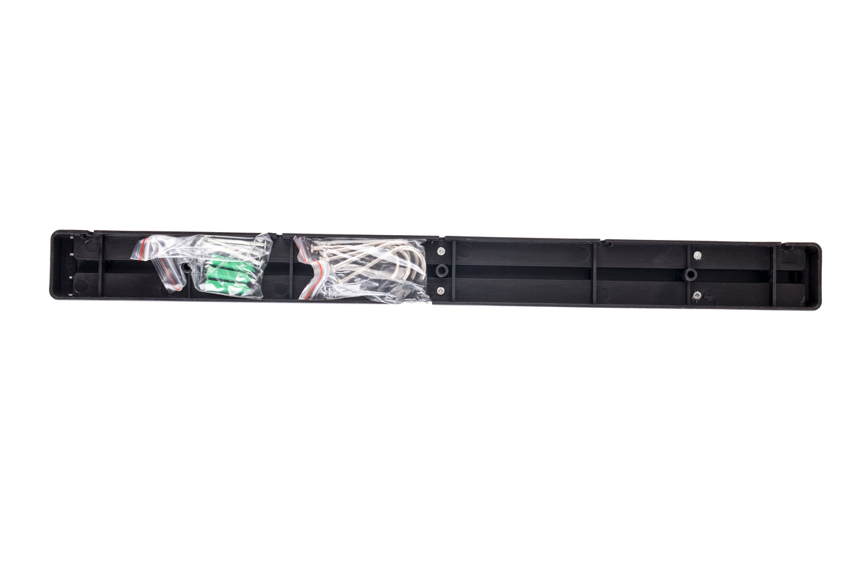 A long, rectangular black plastic case—perfect for Cash & Carry—holds several white wires and a green circuit board, partially wrapped in clear plastic. The 18 inch case is open, revealing empty compartments and electronic components inside on a white background.