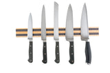 Five kitchen knives with black handles are evenly spaced on a wood magnetic holder that mounts to the wall. Displayed on a white background, the set includes a serrated bread knife and four chef or utility knives with smooth blades.
