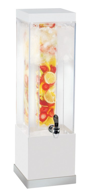 The Luxe Beverage Dispenser features a tall, rectangular, clear 3-gallon infusion chamber filled with ice, sliced lemons, limes, and strawberries. Its white base and silver spigot at the front make serving drinks easy and elegant.
