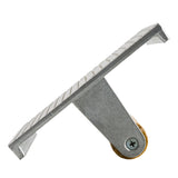 A metal tool with a flat, grooved cast aluminum plate attached to a slanted support and a round brass wheel at the bottom, photographed on a white background.