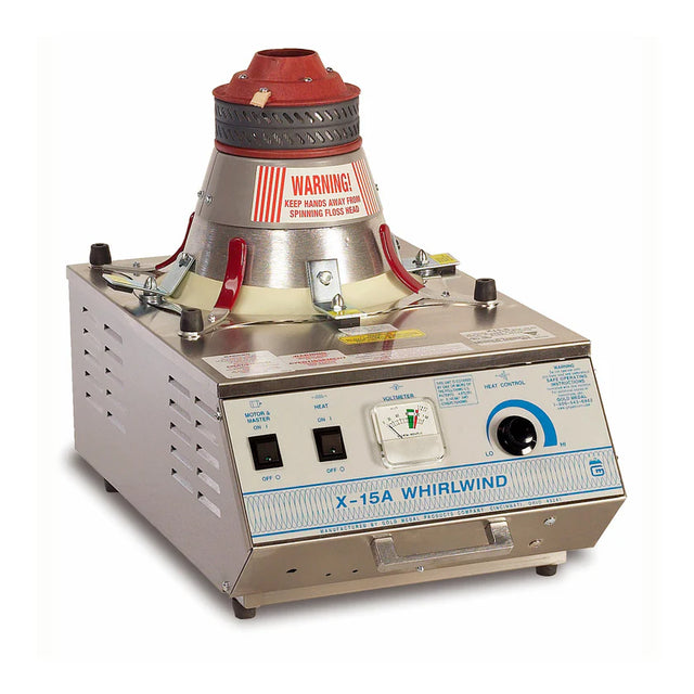 A stainless steel X-15A Whirlwind popcorn machine from Gold Medal Products features a red warning sign, funnel-shaped popping chamber, switches, vents, and a blue-labeled front panel with dials and instructions against a white background.