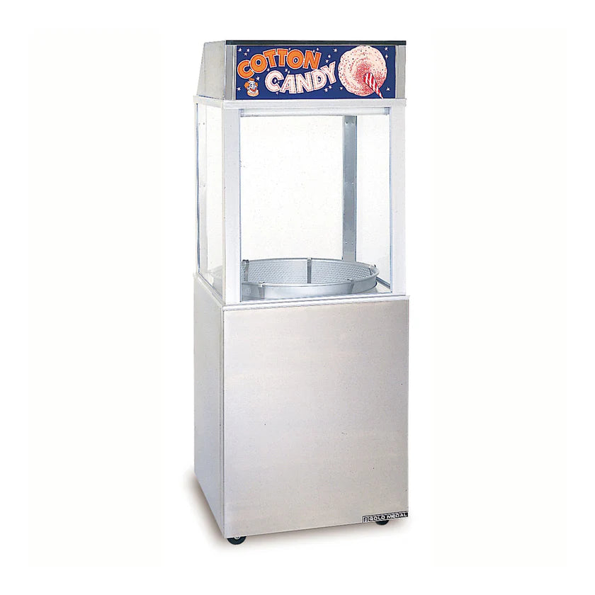 A commercial cotton candy machine by Gold Medal Products with a clear enclosure and stainless steel base. The top features a sign reading “Cotton Candy” in bold, colorful letters and a picture of pink cotton candy on a stick.