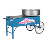 A blue cotton candy cart with a blue cabinet, two large metal wheels, and a flat tabletop. On the right side sits a large silver floss unit. “Cotton Candy” is written in pink and white with a pink cotton candy graphic on the side.