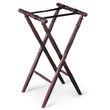 A wooden folding luggage rack with four turned legs and two black fabric straps across the top, featuring a rich mahogany finish. Designed to hold suitcases or serve as a tray stand, the rack stands open against a white background.