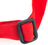 Close-up of a red fabric strap with an adjustable neck threaded through a rectangular black plastic buckle, set against a white background. The texture is visible, highlighting the quality details of this chef approved bib apron.